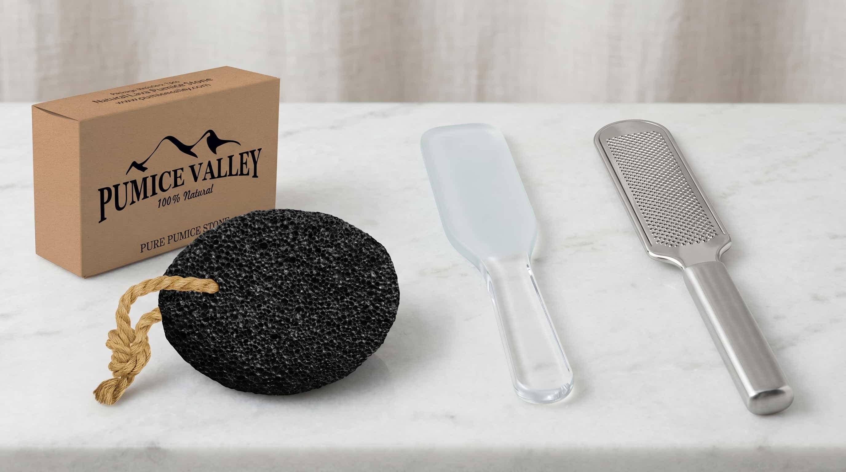 A pumice stone, a glass foot file, and a foot rasp arranged side by side on a clean neutral surface.